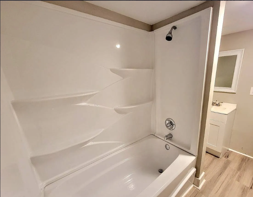 a white bathroom with a shower and a tub