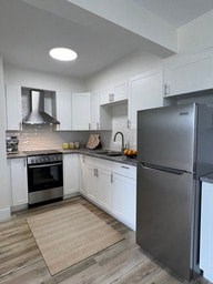A modern kitchen with a refrigerator on the right.