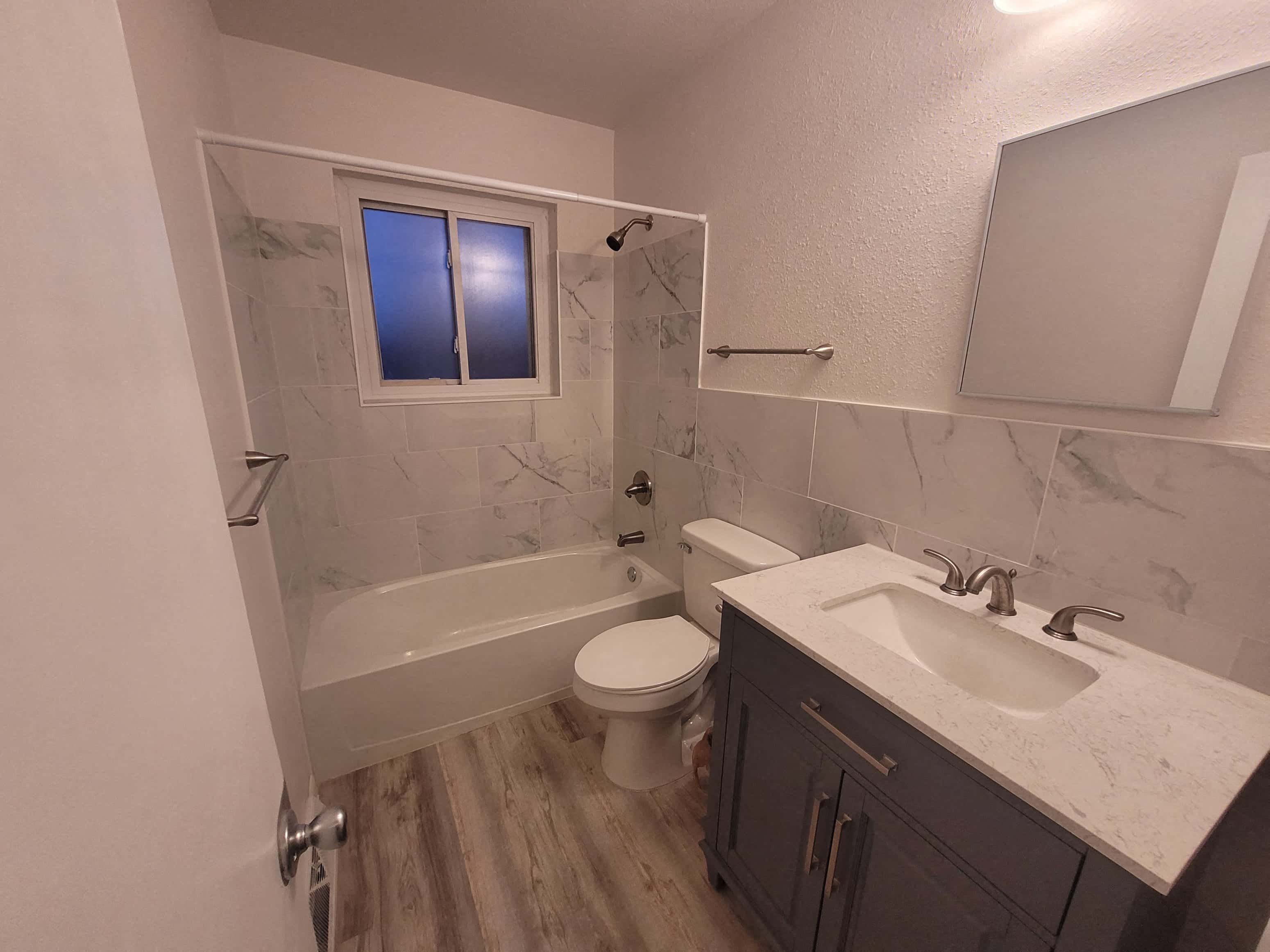 a bathroom with a sink toilet and a bath tub