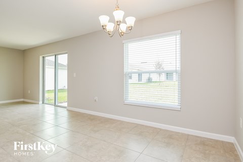 the living room and dining room of a house with a large window