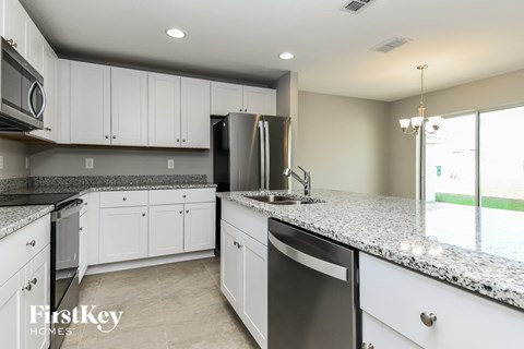 A kitchen with granite countertops and stainless steel appliances.