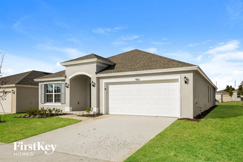 a beige house with a white garage door