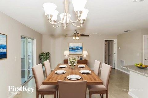 A dining room with a wooden table set for six.