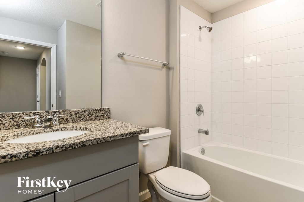 a bathroom with a toilet sink and tub and a shower