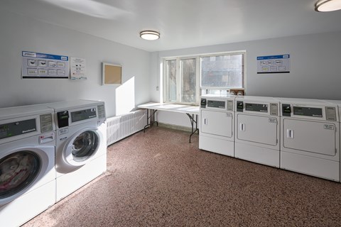 A laundry room with washers and dryers.