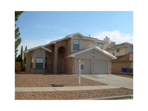 A house with a brown roof and a grey garage door.