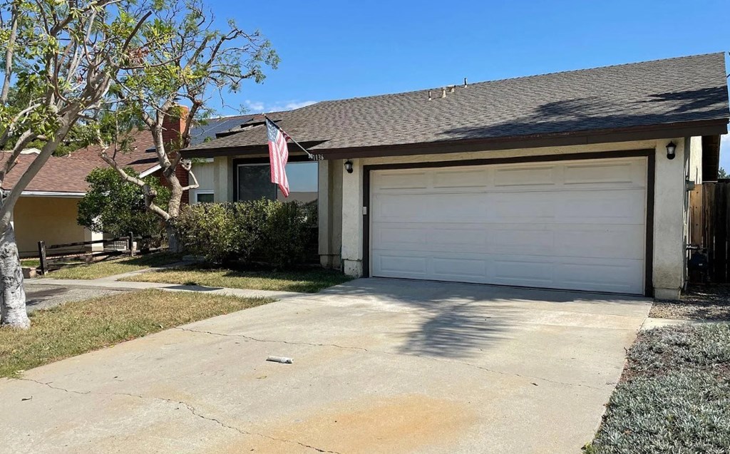 a white garage door in front of a house