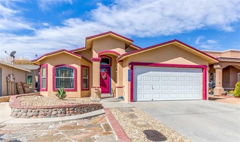 a house with a garage door and a driveway