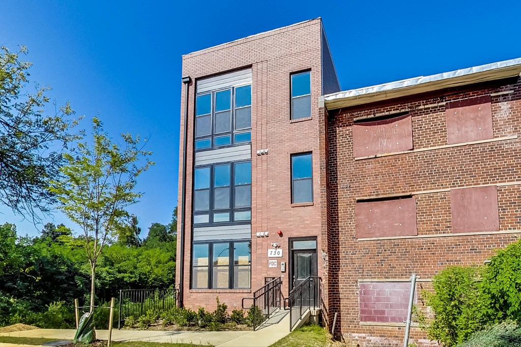 the front of a brick building with a clear blue sky