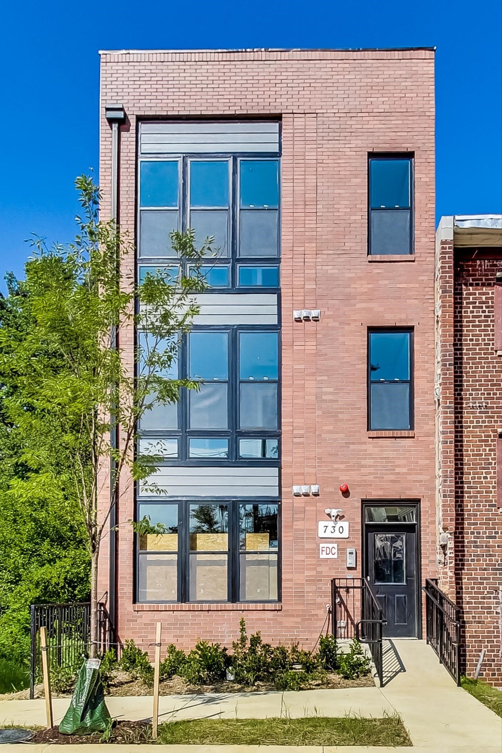 a brick building with a sidewalk in front of it