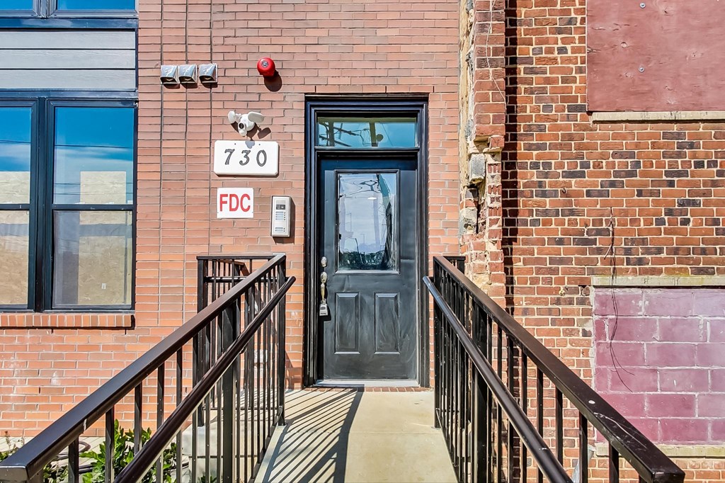 the entrance to a brick building with a black door