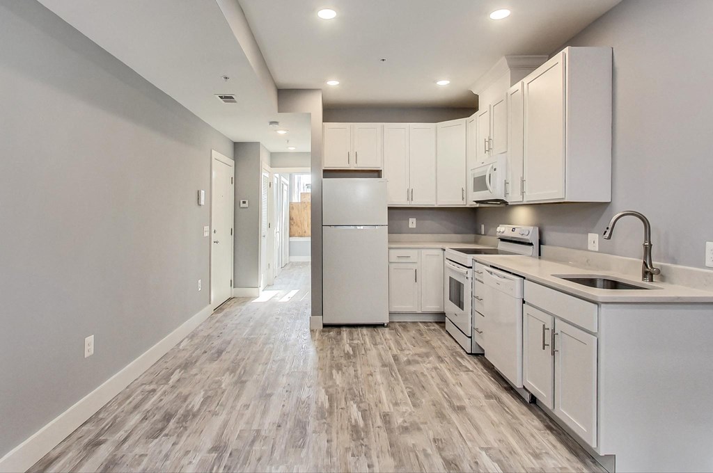 the kitchen of a new home with white cabinets and stainless steel appliances