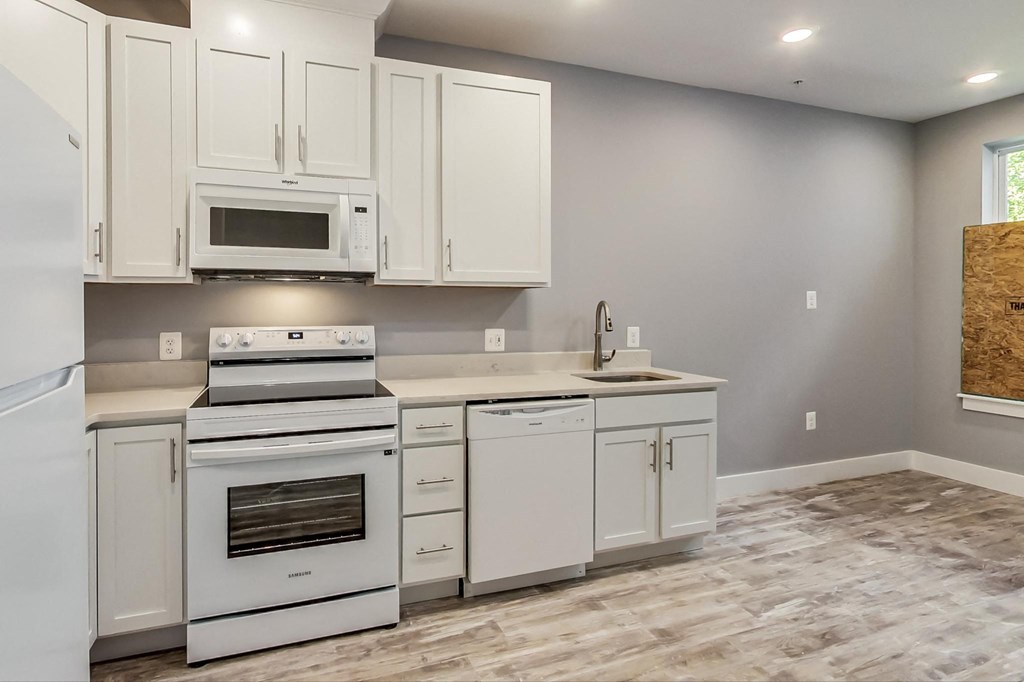 the kitchen of a new home with white cabinets