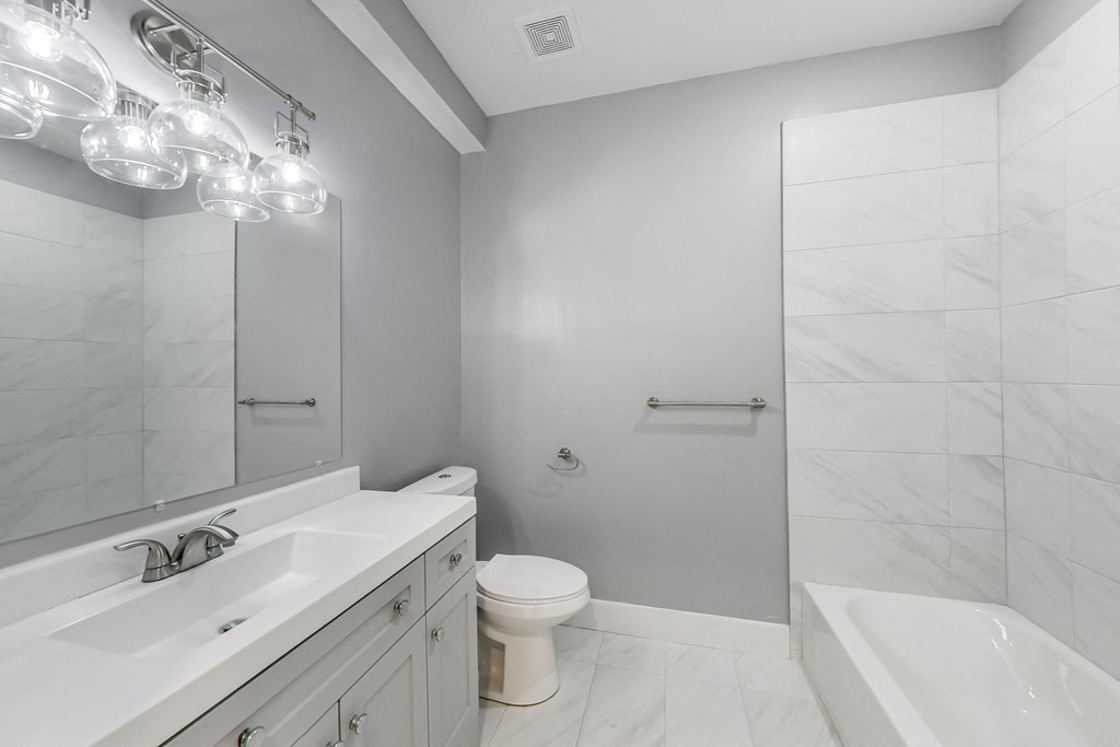 a bathroom with a sink toilet and a shower