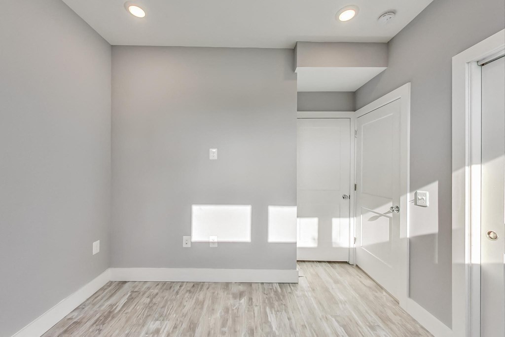 the living room is empty and has a door to the closet