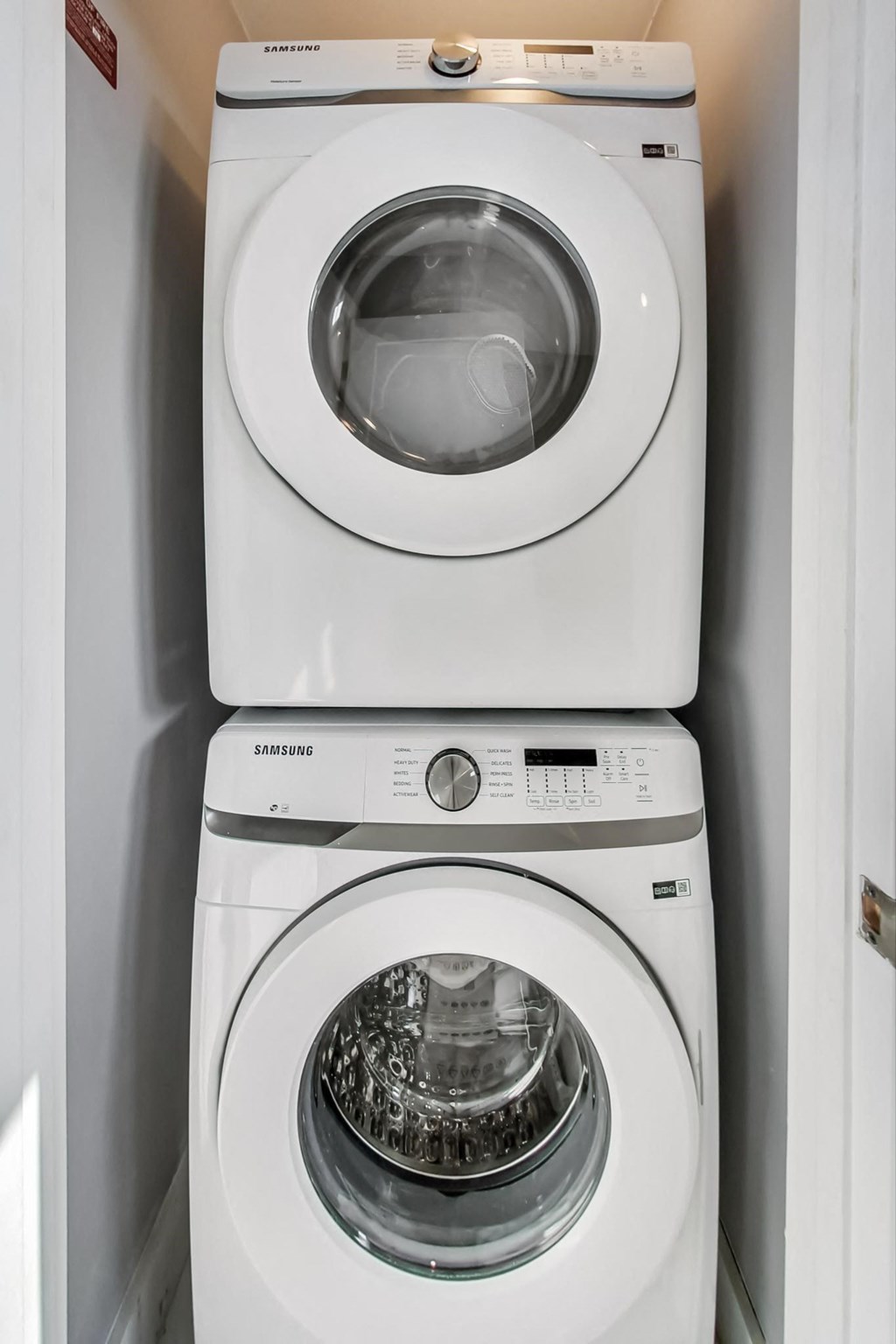 a white washer and dryer in a small laundry room