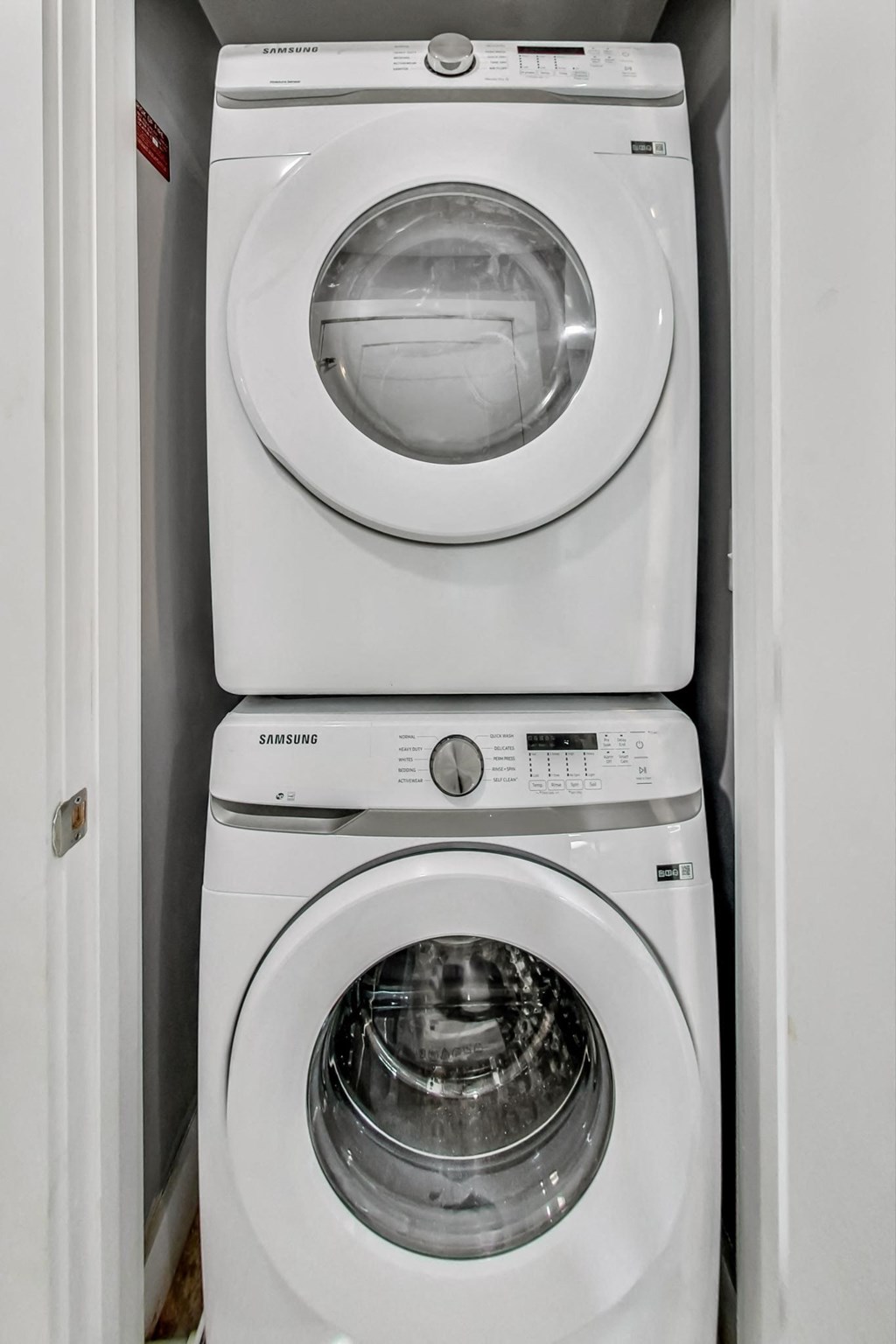 a white washer and dryer in a small laundry room