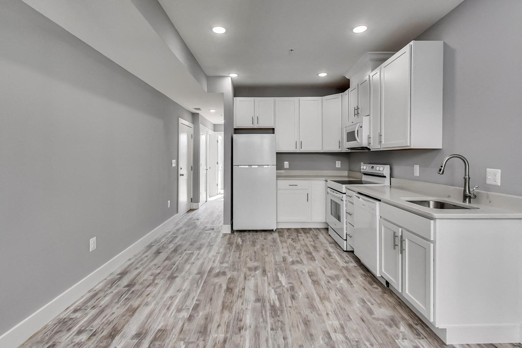 the kitchen of a new home with white cabinets and stainless steel appliances