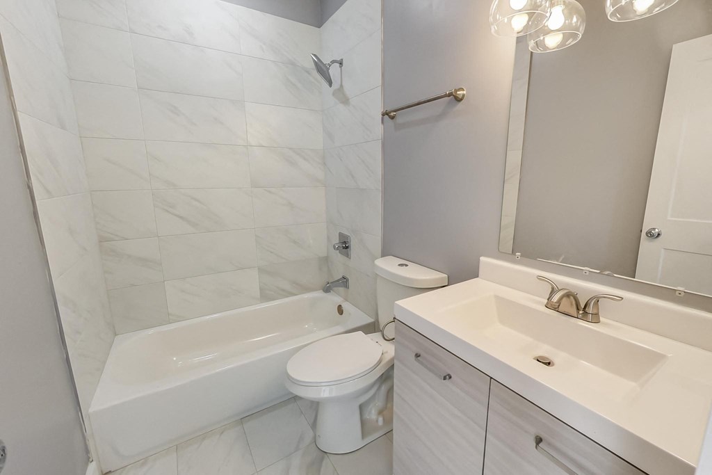 a bathroom with a sink toilet and a tub