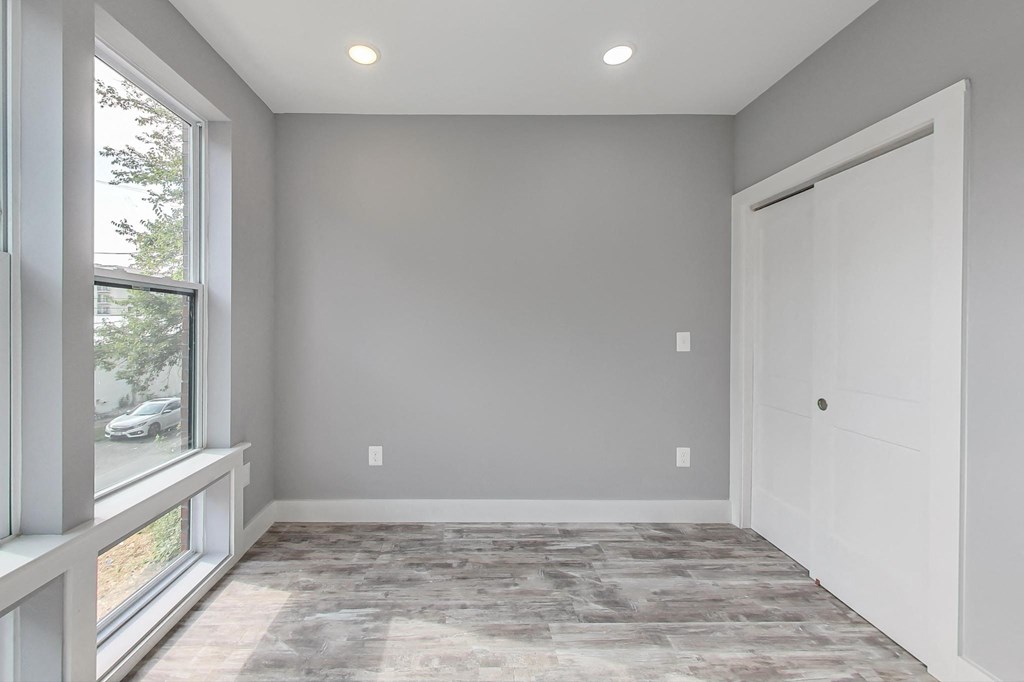 an empty room with a window and a door