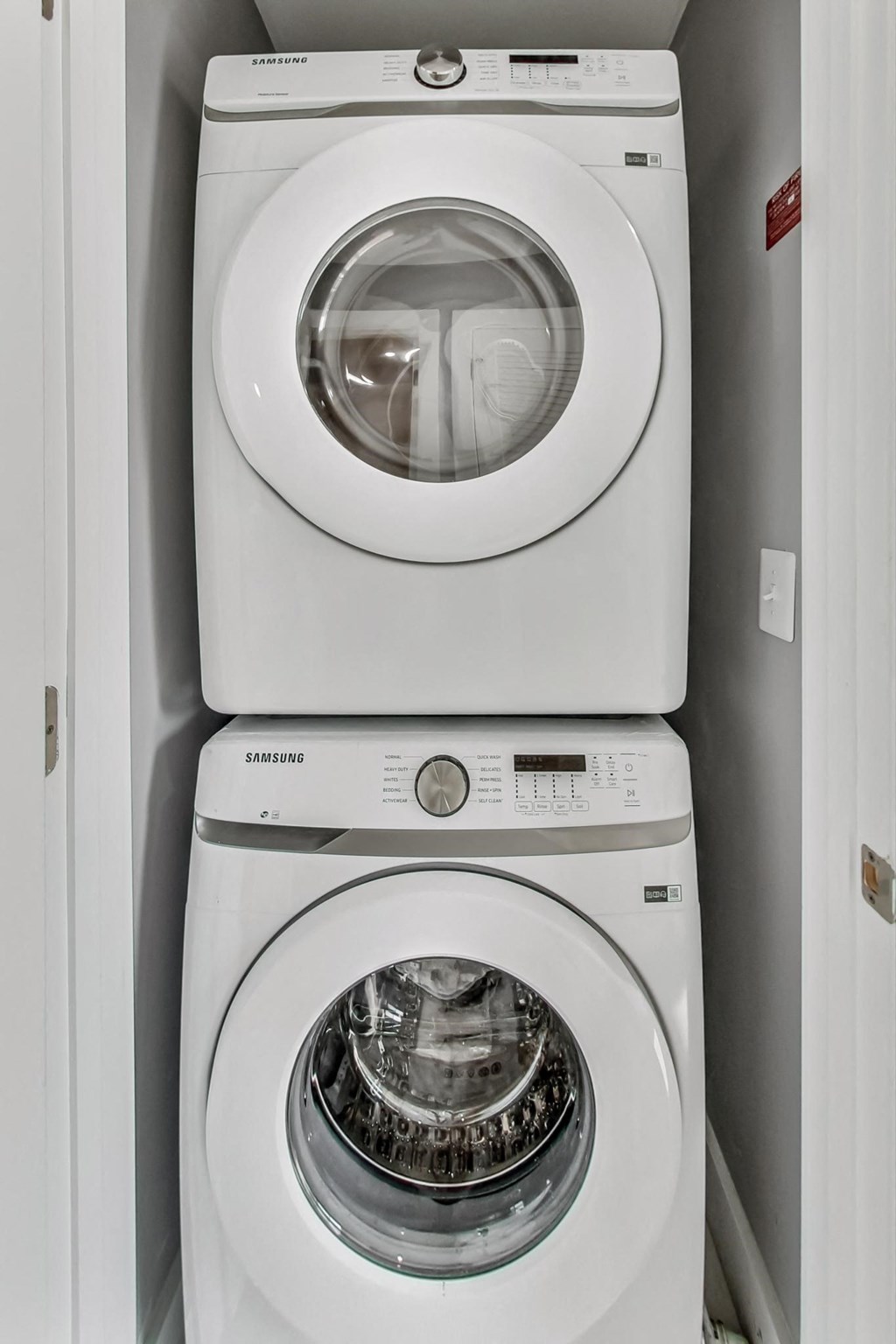 a white washer and dryer next to each other in a laundry room