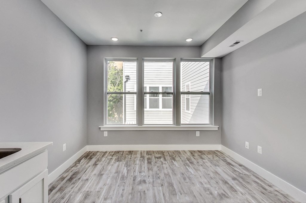 the living room of a new home with a large window