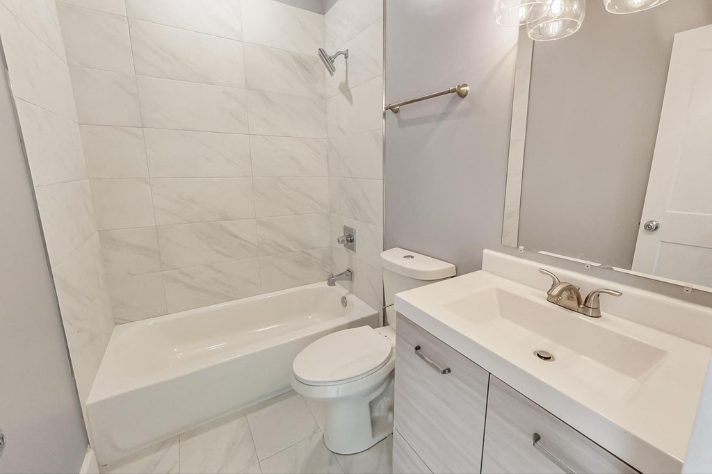 a bathroom with a sink toilet and a tub