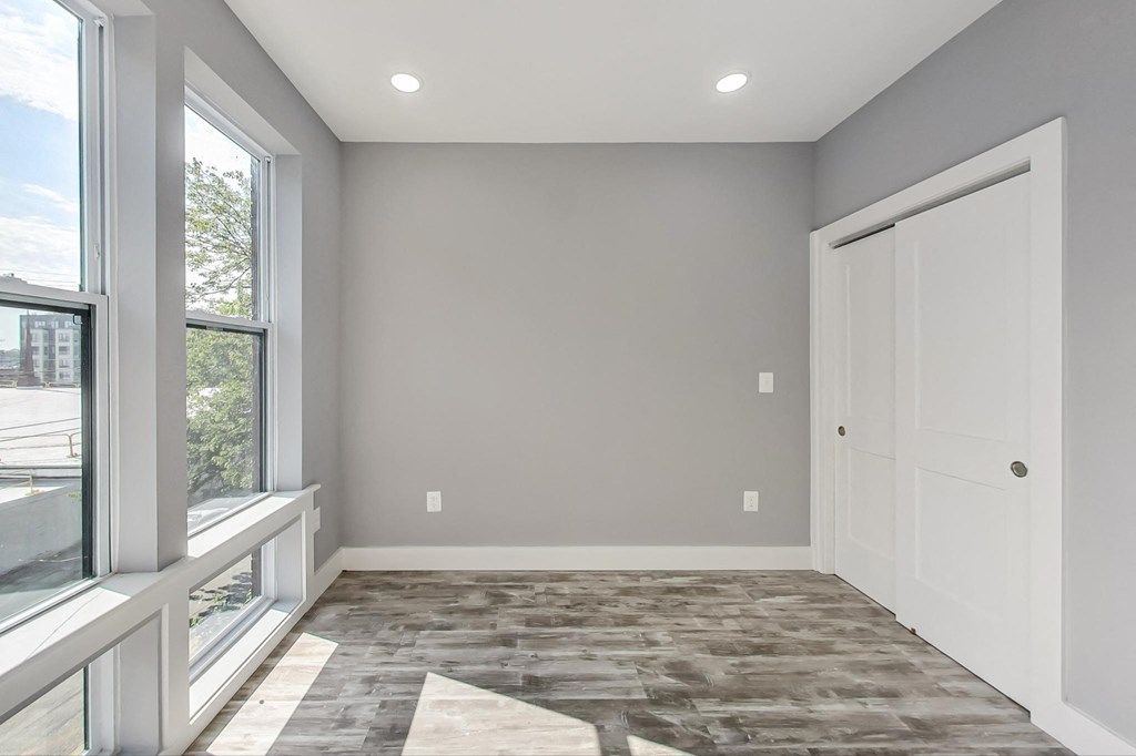 an empty room with a window and a door