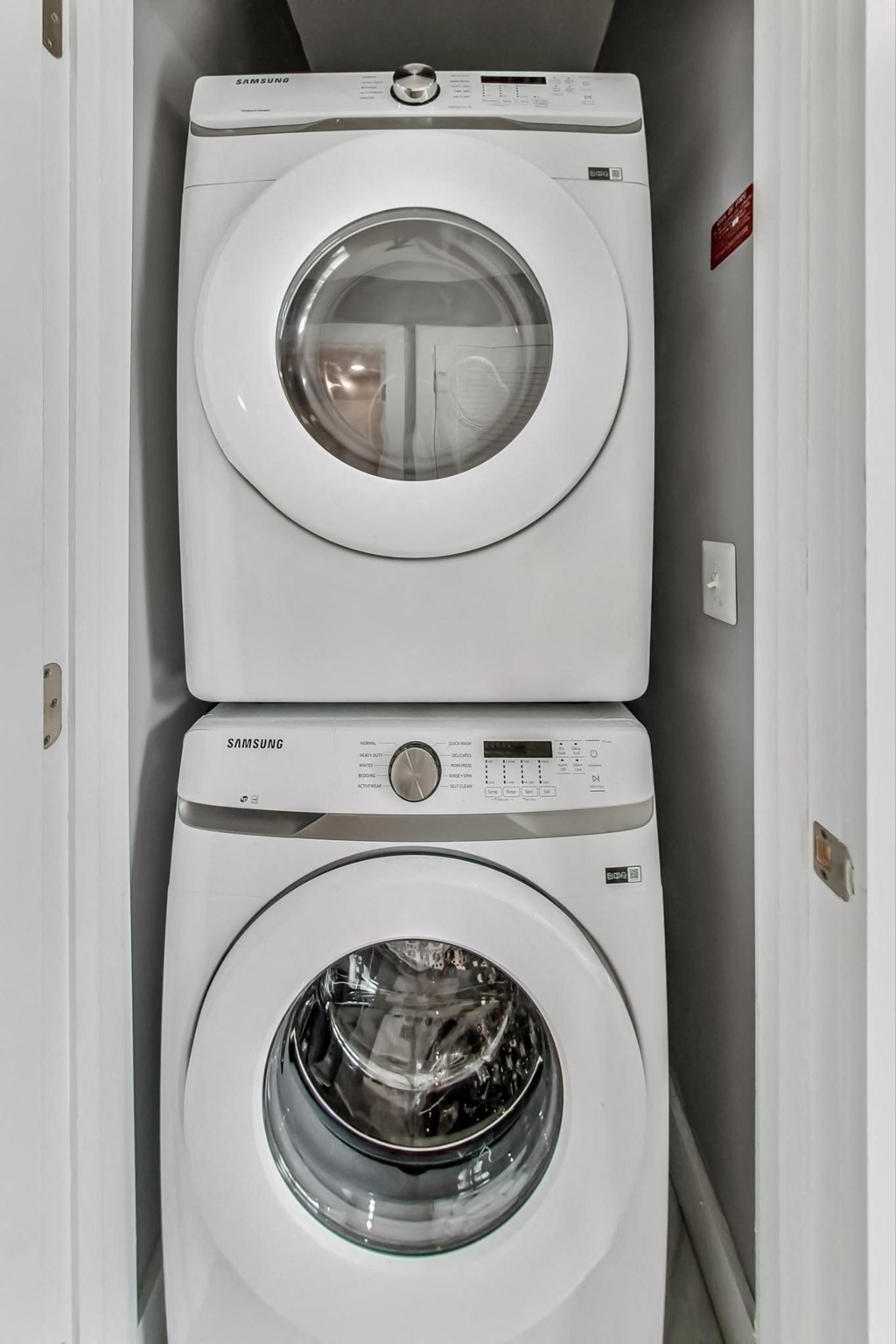 a white washer and dryer next to each other in a laundry room