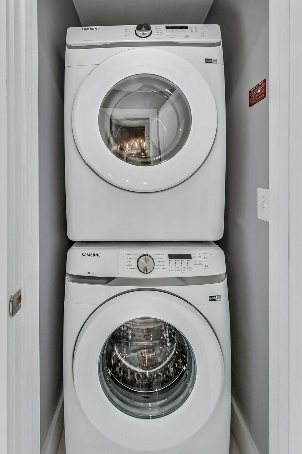 a white washer and dryer next to each other in a laundry room