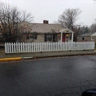 a white picket fence in front of a house