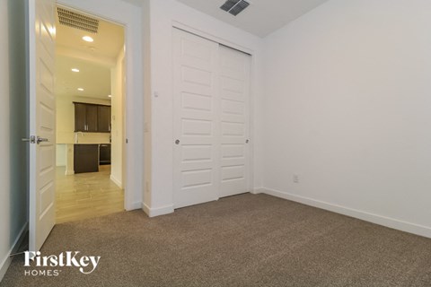 a bedroom with a closet and a door to a bathroom