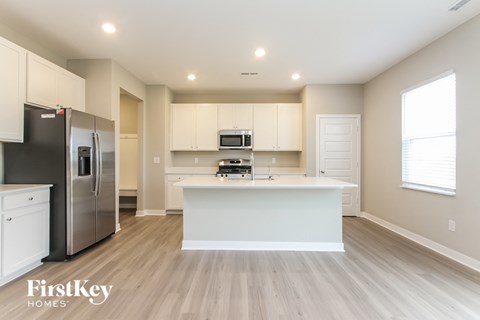 a large kitchen with white cabinets and a white counter top