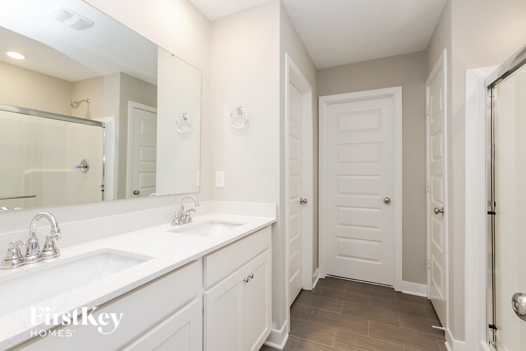 A bathroom with a double sink and a mirror.