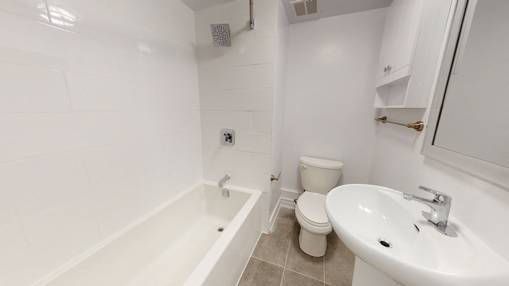 a bathroom with a sink toilet and bath tub