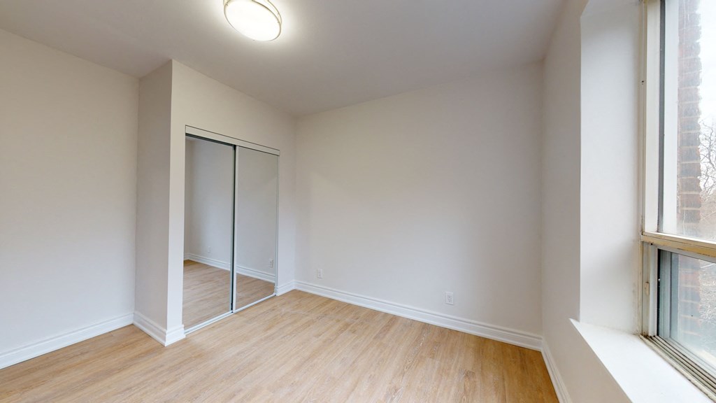 an empty living room with white walls and wood flooring