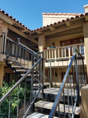 a house with stairs and a balcony