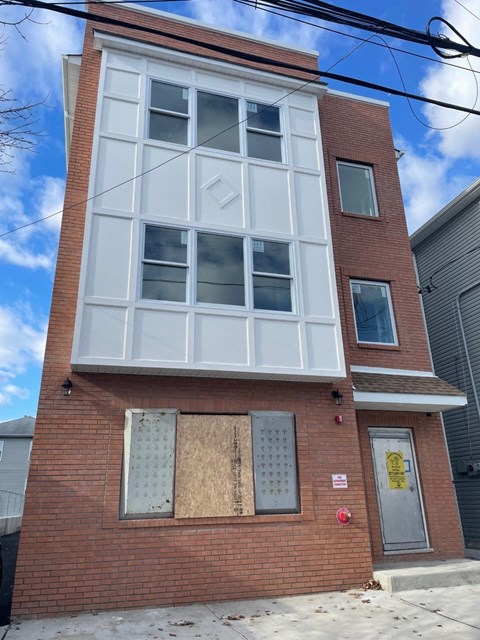 the front of a brick building with a large window