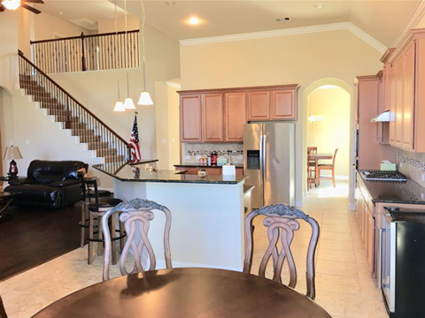 a kitchen and dining room with a table and chairs