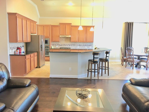 an open kitchen and living room with a couch and a table