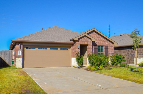 A house with a brown garage door in front of it.