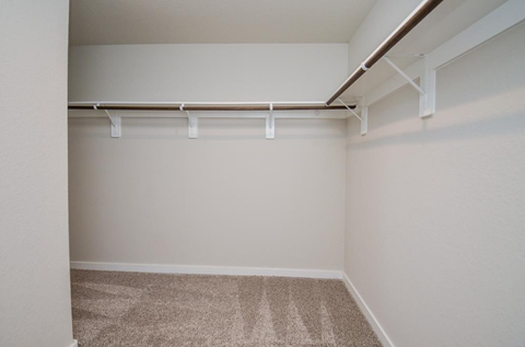 A room with a carpeted floor and a white wall.