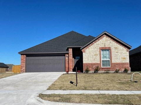 A house with a garage and a driveway.
