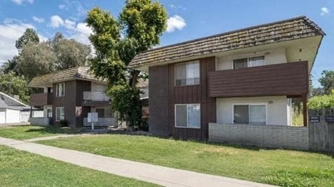 a house with a sidewalk and grass in front of it