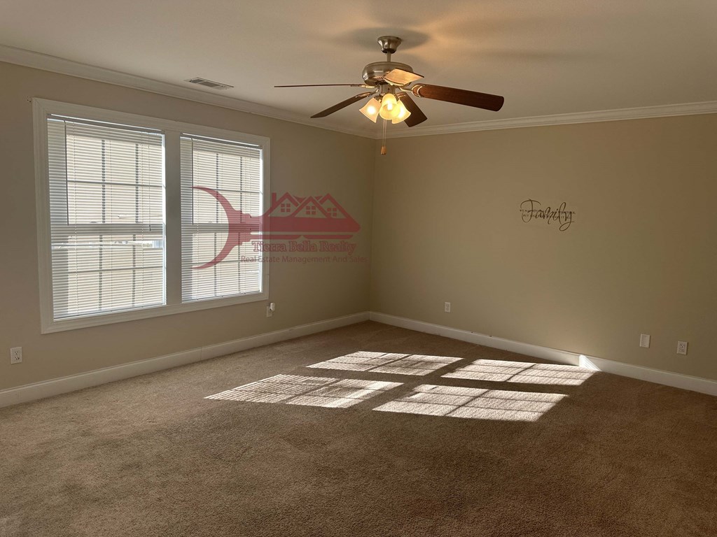 a living room with a ceiling fan and a window