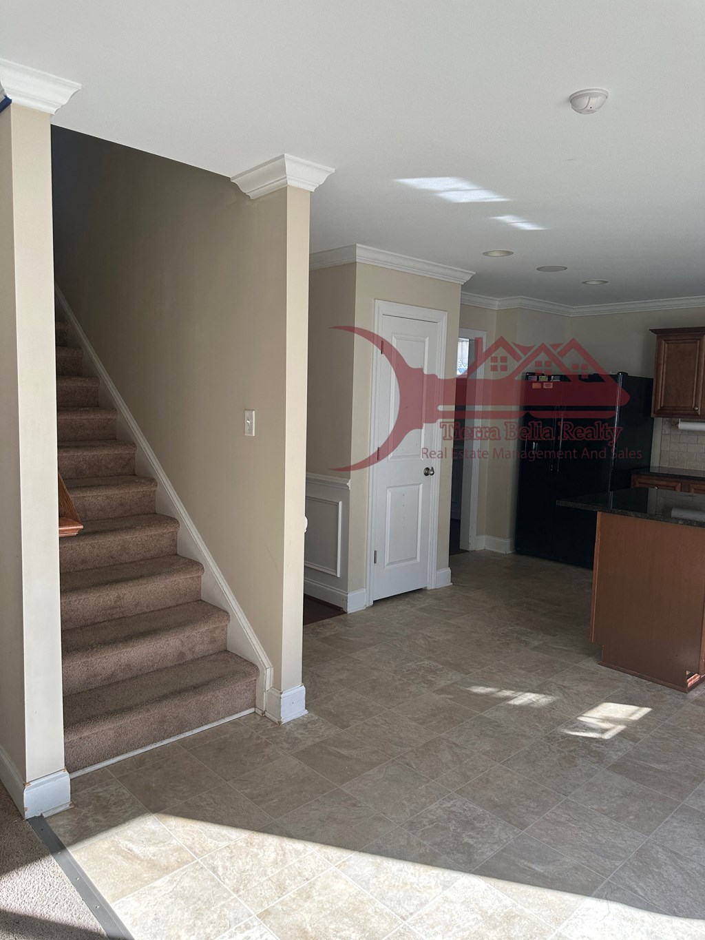 a virtual staging of a living room and stairs in a home