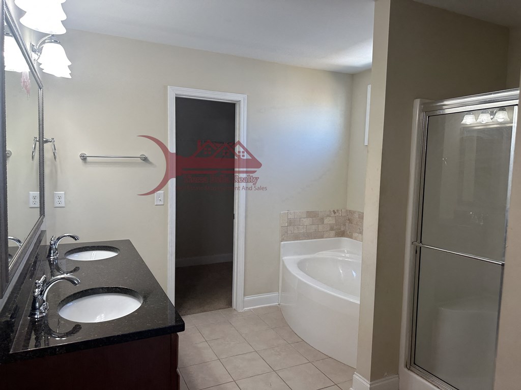 a small bathroom with a tub and a sink and a mirror