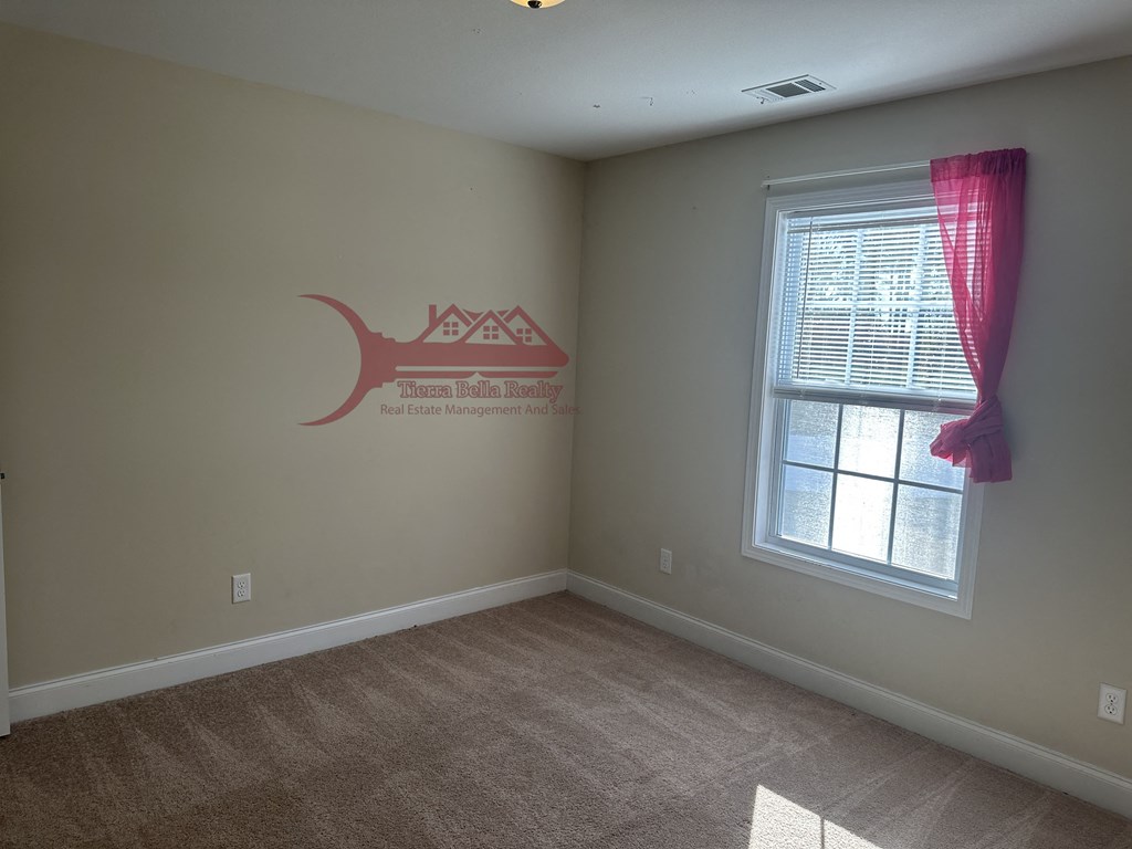 a bedroom with a window and a wall with a fish on it