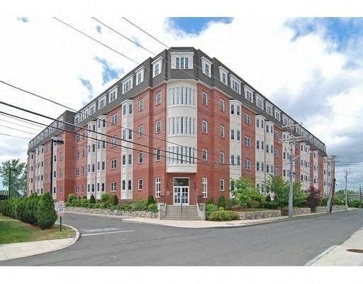 a large brick apartment building on the corner of a street