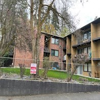 an apartment building with a no parking sign in front of it